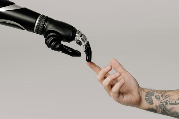 A robot holding a human's hand. Representing the power of artificial intelligence.